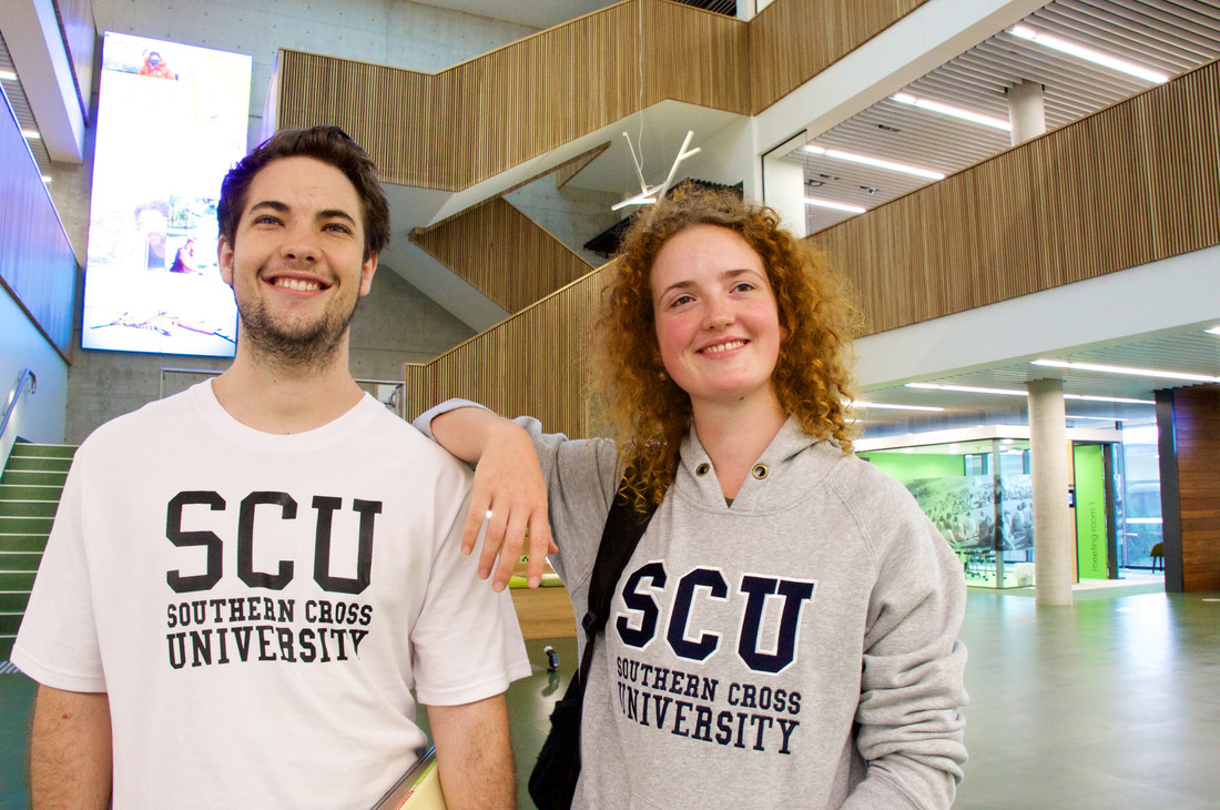Two smiling Southern Cross University students in the learning centre